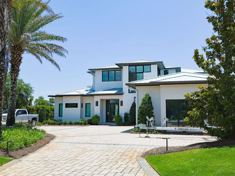 Front exterior and driveway of a modern coastal villa in Florida