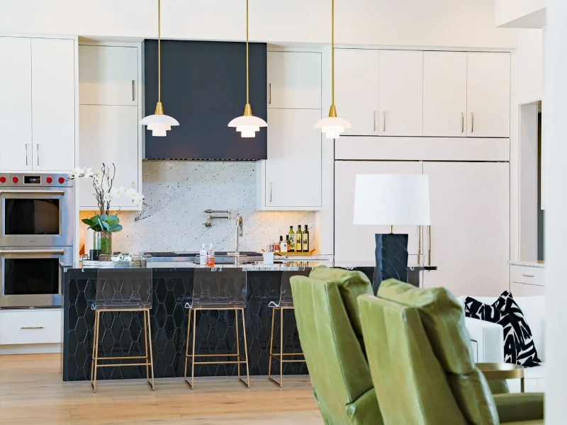 Kitchen cabinetry detail with tall storage, white panels, and dark countertop