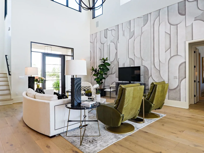 Living room with feature wall, lounge seating, wood flooring, and modern lighting