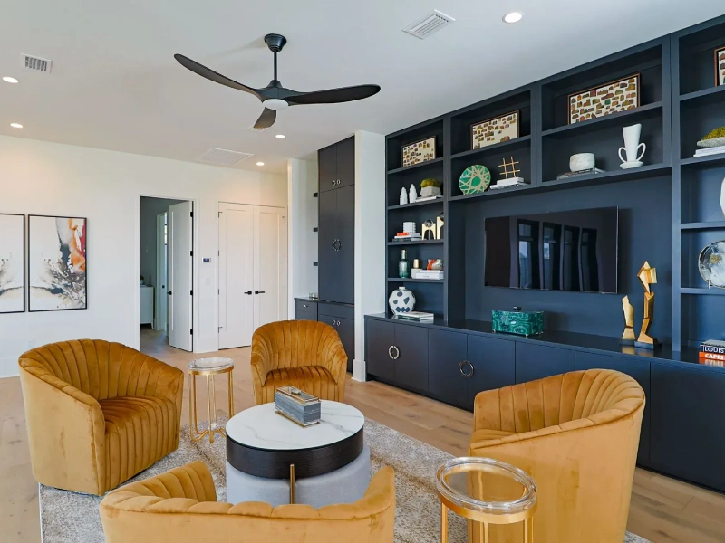 Living room TV wall with built-in cabinetry and dark blue storage units
