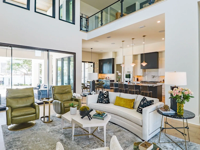 Open-plan living room and kitchen with large windows and coordinated finishes
