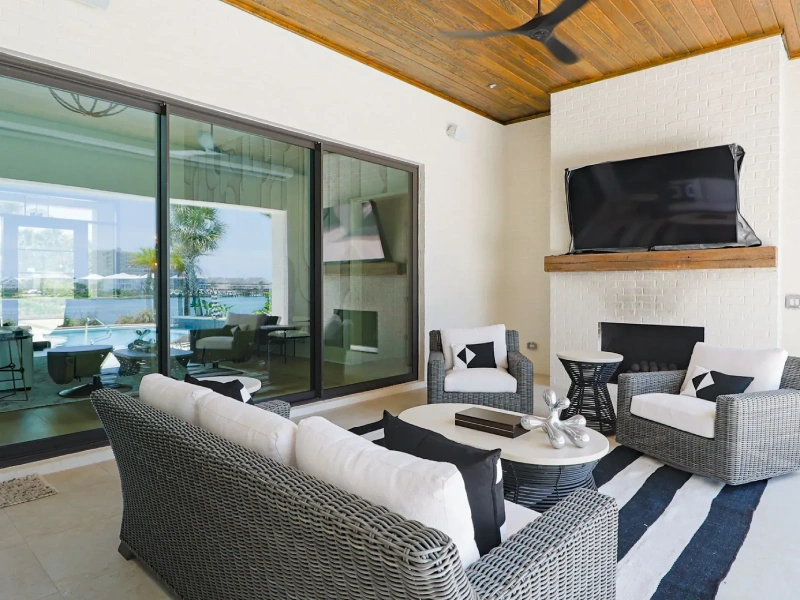 Outdoor lounge area with sliding glass doors and covered terrace