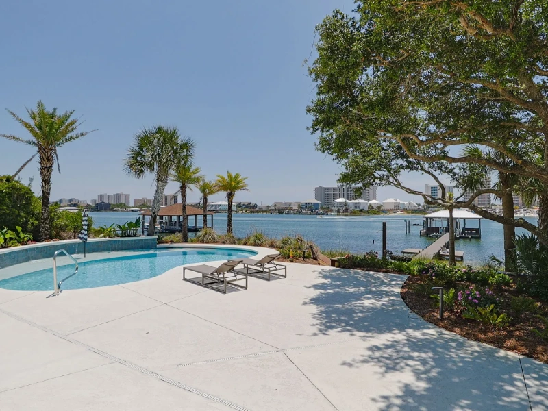 Waterfront pool area with terrace landscaping at a Florida coastal villa
