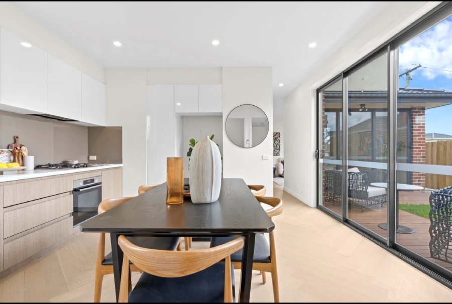 Kitchen and dining space with cabinetry and sliding doors in an Australia private villa