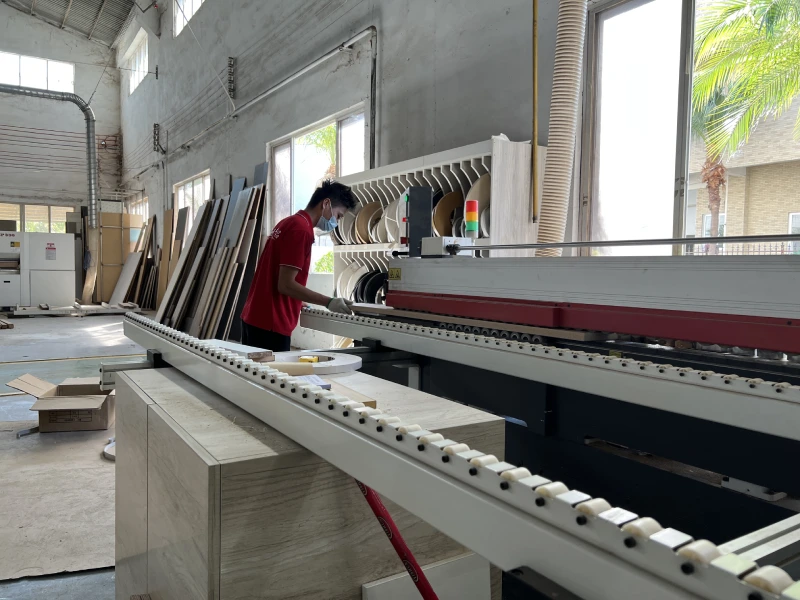 Cabinet edge banding machine working inside George Group China workshop