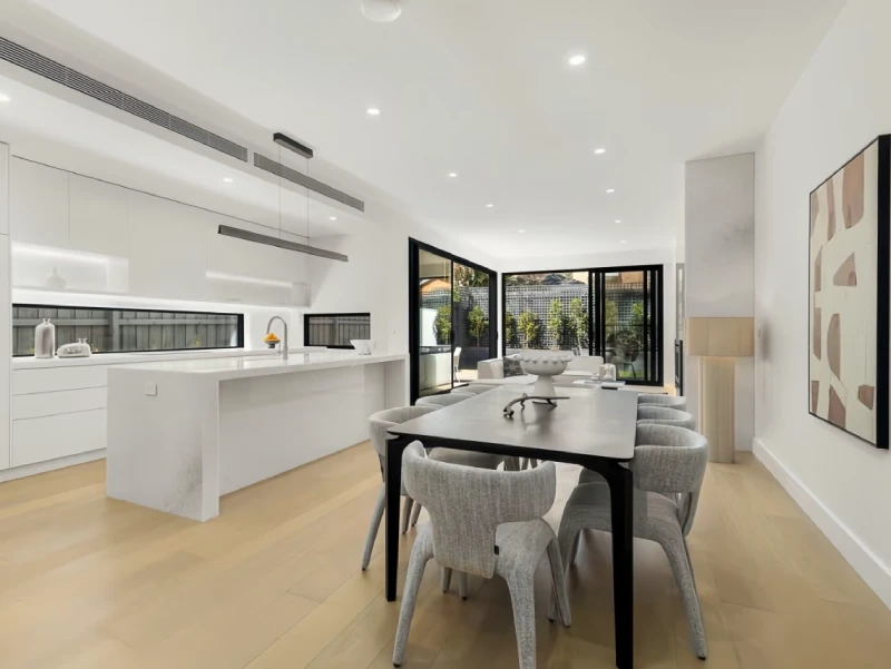 Kitchen and dining area with cabinetry and flooring in a Melbourne private villa