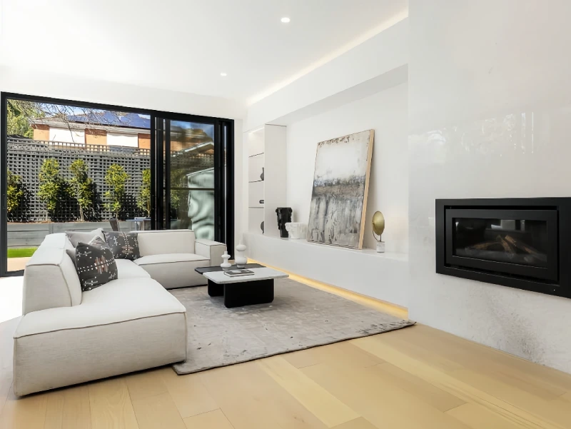 Living room with fireplace, flooring, and wall finishes in a Melbourne private villa