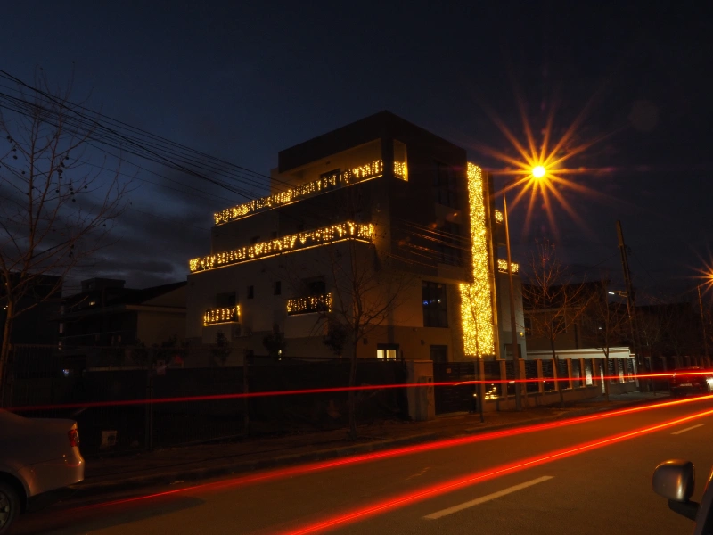 Night exterior view of a Romania apartment building with illuminated facade