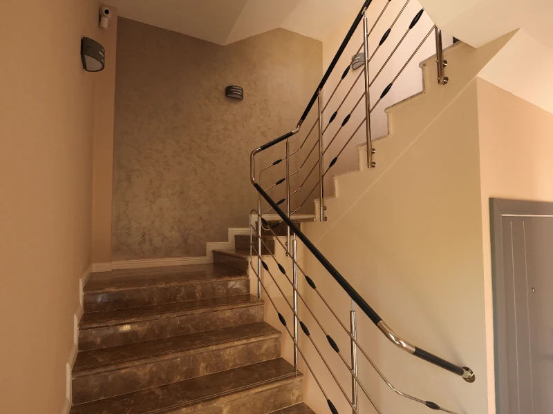 Interior staircase in a Romania apartment building with light stone steps